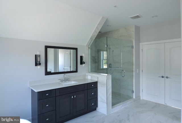 bathroom with a shower with door, vaulted ceiling, tile floors, and vanity