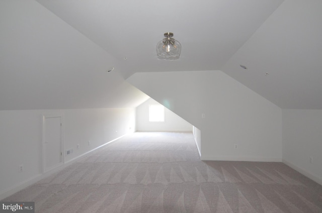 bonus room featuring light carpet and lofted ceiling