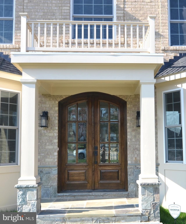 property entrance with a balcony and french doors