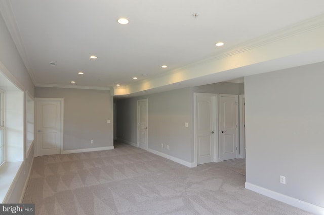 carpeted empty room featuring crown molding