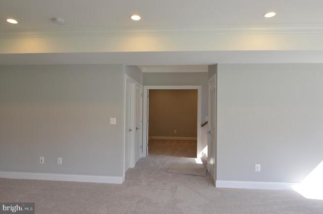 spare room with light carpet and ornamental molding