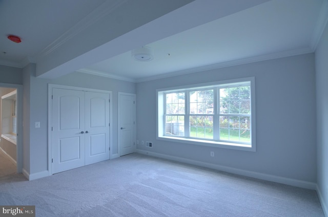 unfurnished bedroom with light carpet, multiple windows, and ornamental molding