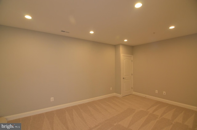 unfurnished room featuring light colored carpet