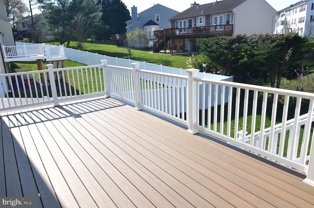 wooden terrace with a yard