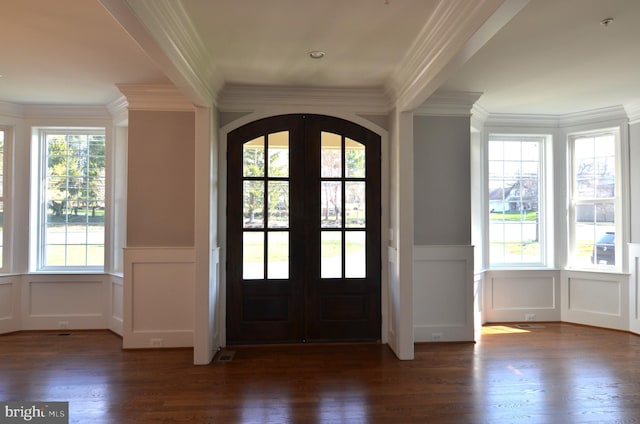 entrance foyer with french doors, crown molding, and dark wood-type flooring