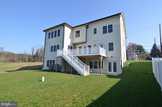 back of house featuring a lawn and a wooden deck