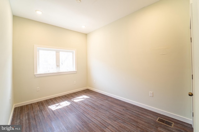 empty room with dark hardwood / wood-style floors