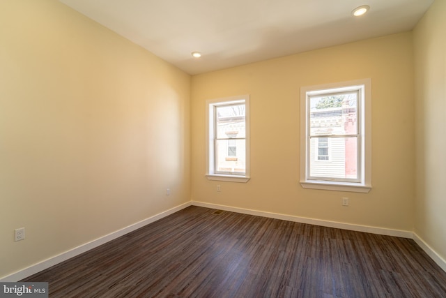 empty room with dark hardwood / wood-style flooring