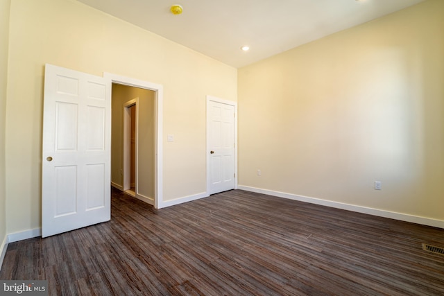 empty room featuring dark hardwood / wood-style flooring