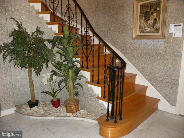 stairway featuring light tile floors