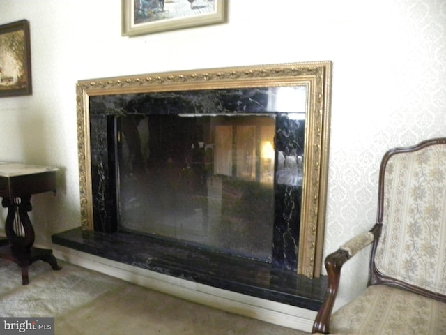 interior details featuring carpet flooring and a high end fireplace