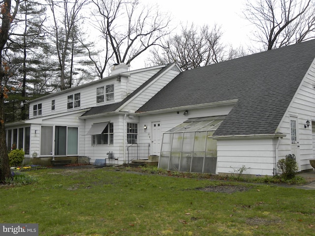 back of property featuring a yard