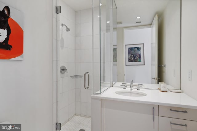 bathroom featuring an enclosed shower and vanity