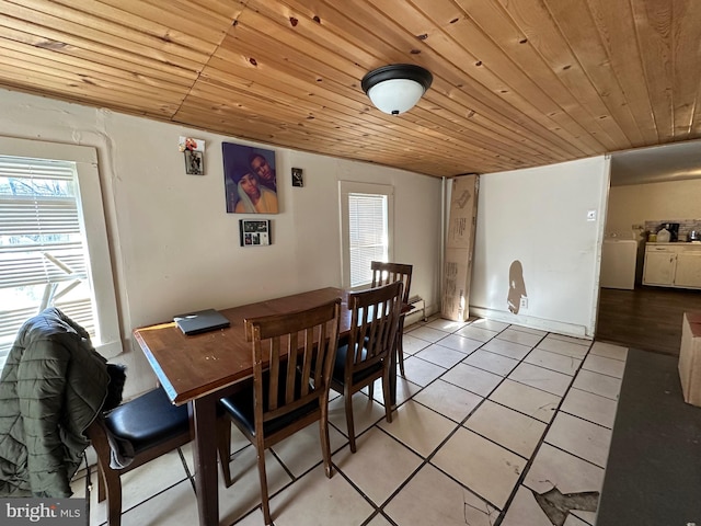 dining room featuring wooden ceiling, light tile floors, and a baseboard heating unit