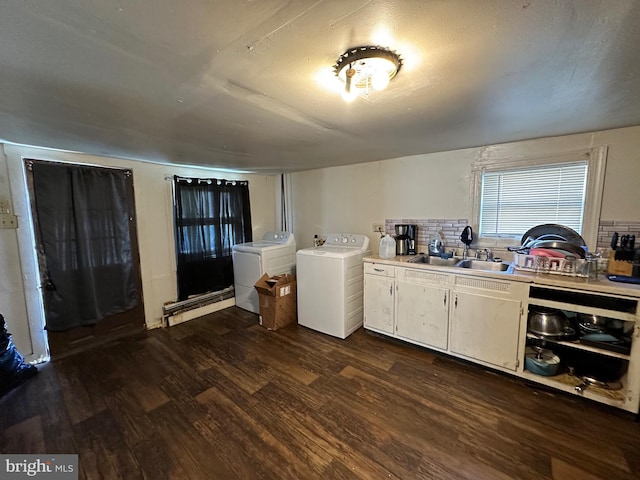 kitchen with backsplash, dark wood-type flooring, sink, white cabinets, and washing machine and clothes dryer