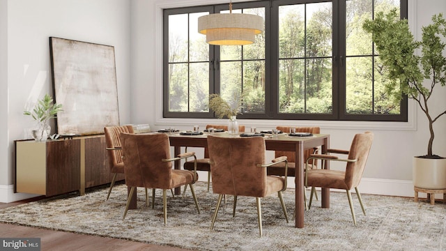 dining area with wood finished floors and baseboards