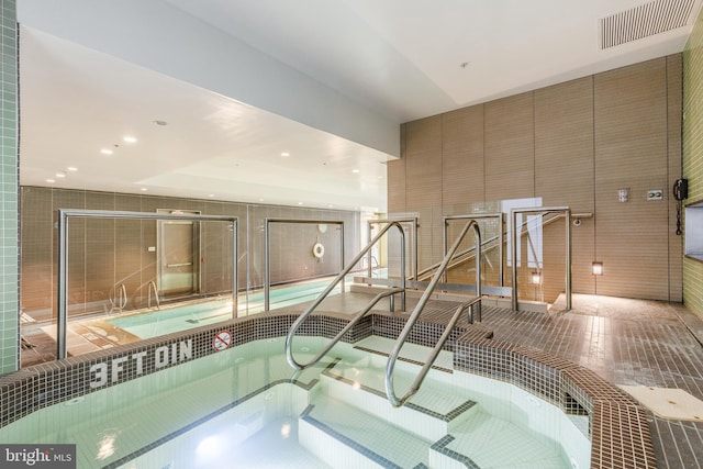 view of pool with an indoor in ground hot tub