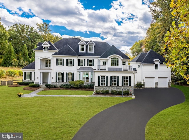 view of front of property with a front yard and a garage