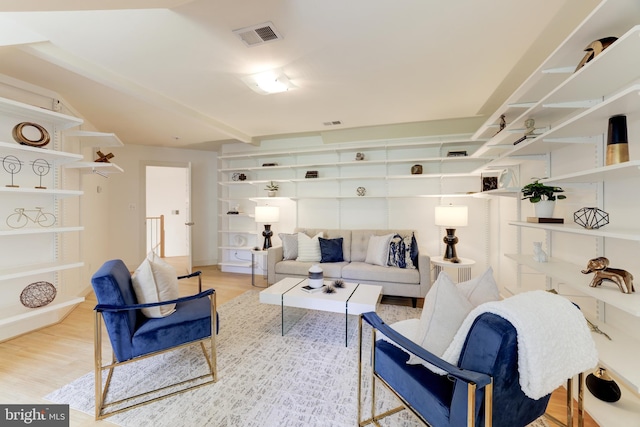 living room with beam ceiling and light hardwood / wood-style floors