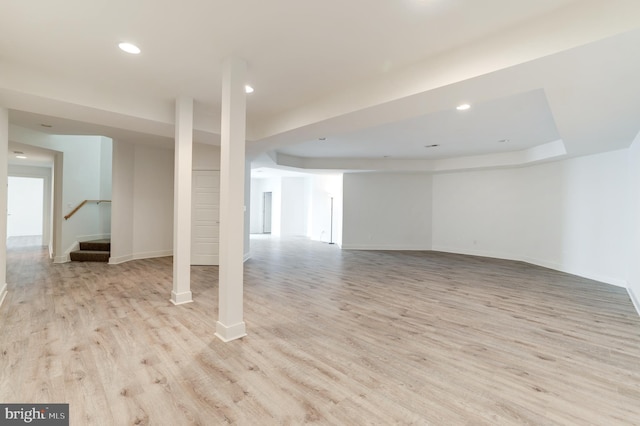 basement with light hardwood / wood-style flooring