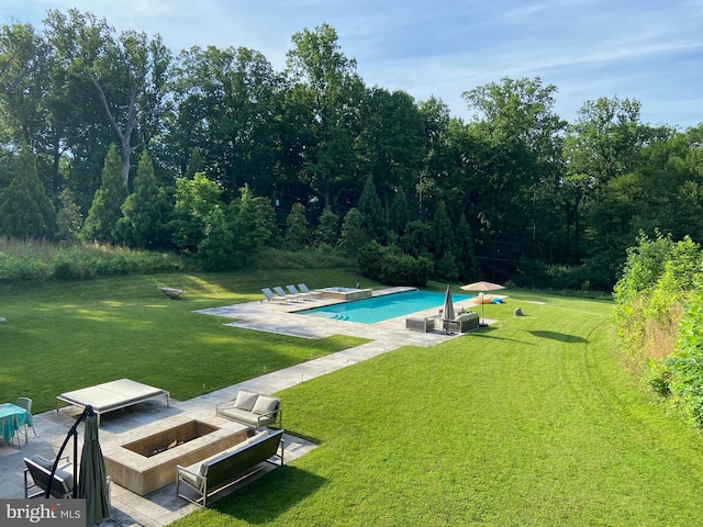 view of pool with a patio area and a yard