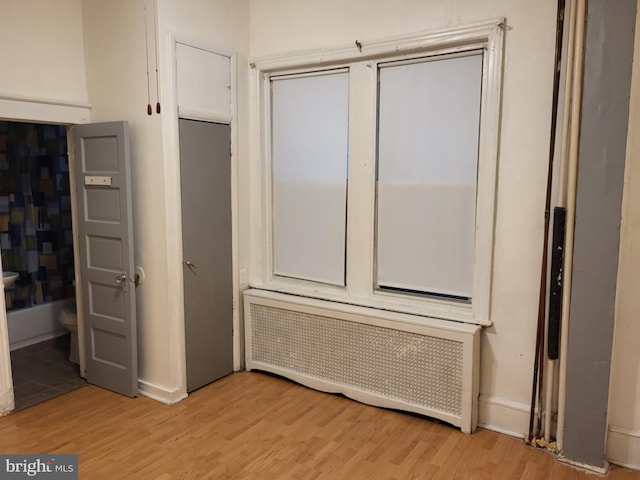 interior space with light hardwood / wood-style flooring and radiator