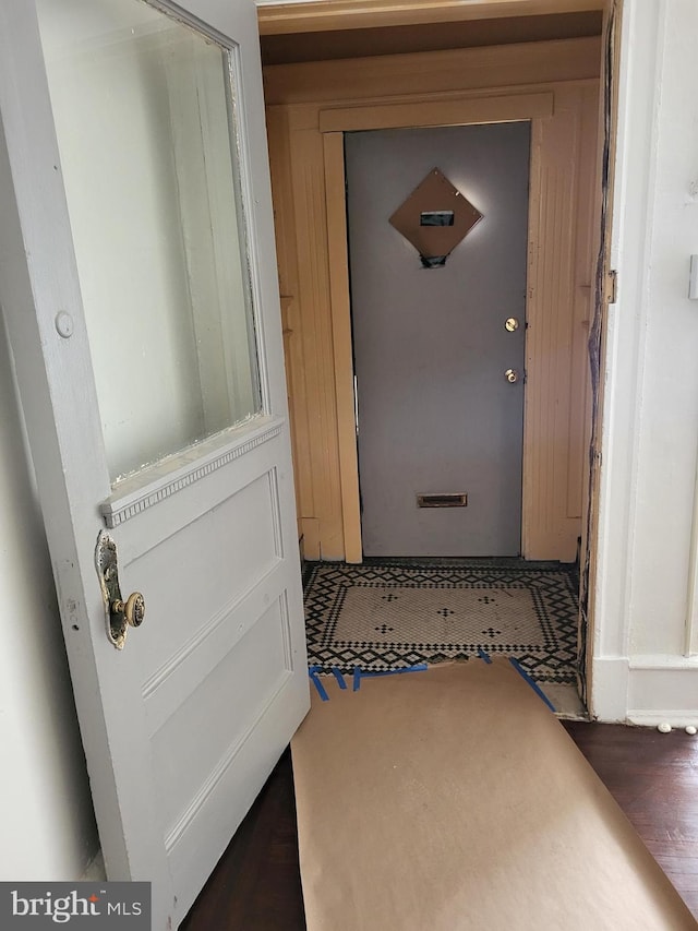 hallway with dark hardwood / wood-style flooring