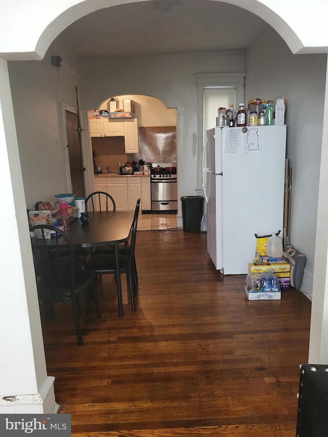 dining area with dark hardwood / wood-style floors