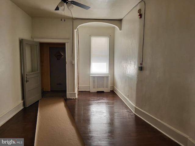 empty room featuring ceiling fan and dark hardwood / wood-style flooring