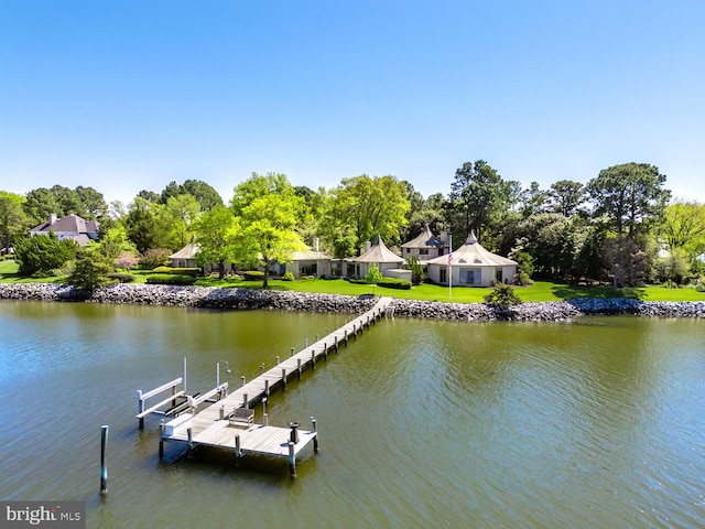 dock area with a water view and a yard