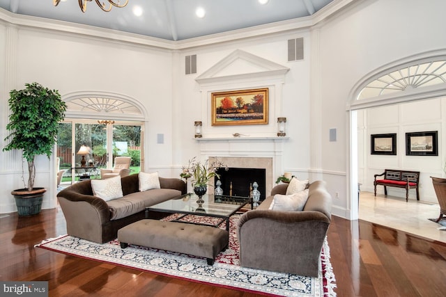 living room featuring visible vents, wood finished floors, and a fireplace