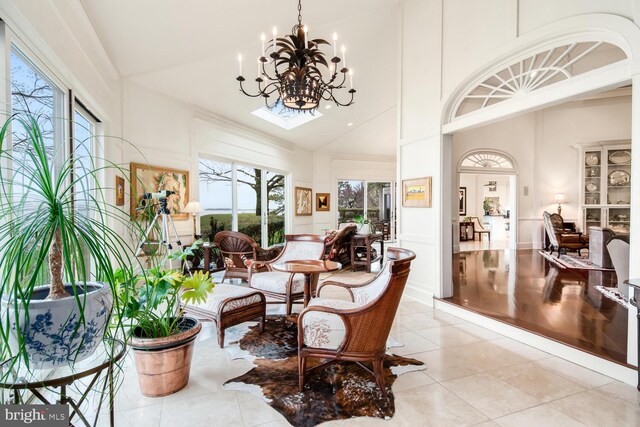 sunroom with lofted ceiling and a chandelier