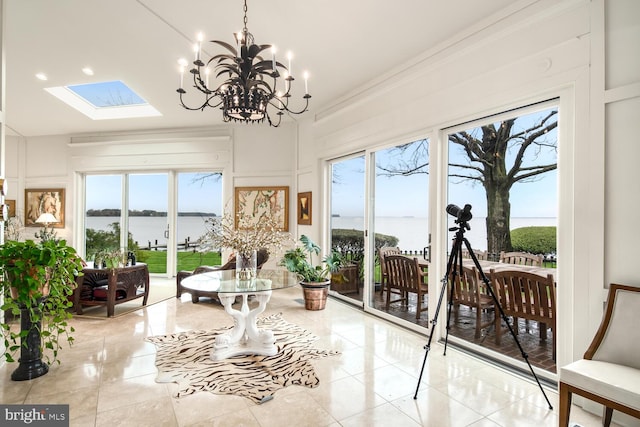 sunroom / solarium with plenty of natural light, a skylight, and a water view