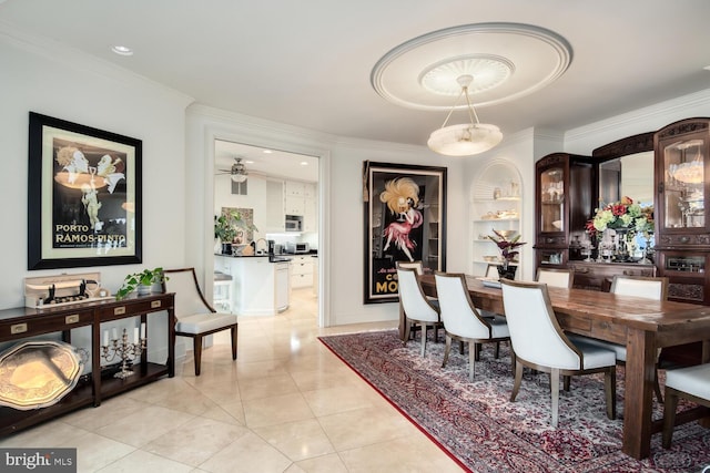 dining space featuring crown molding, light tile patterned floors, and built in features