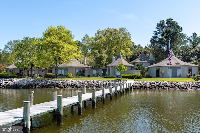 dock area featuring a water view and a lawn