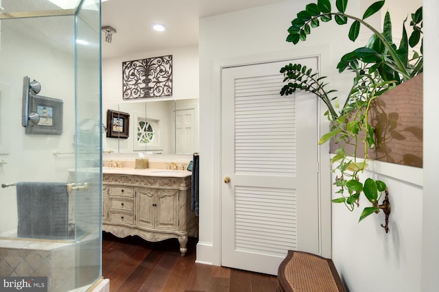 bathroom featuring vanity, recessed lighting, wood finished floors, and a stall shower