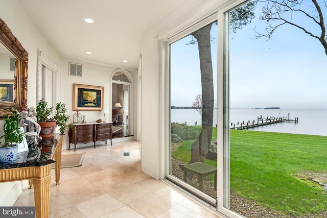 doorway with visible vents, a water view, recessed lighting, crown molding, and light tile patterned floors