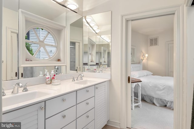 bathroom featuring a sink, visible vents, ensuite bath, and double vanity