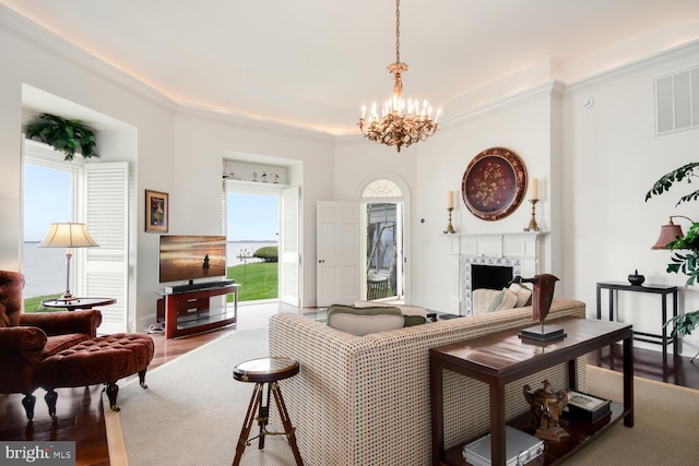 living room featuring plenty of natural light, wood finished floors, and a high end fireplace