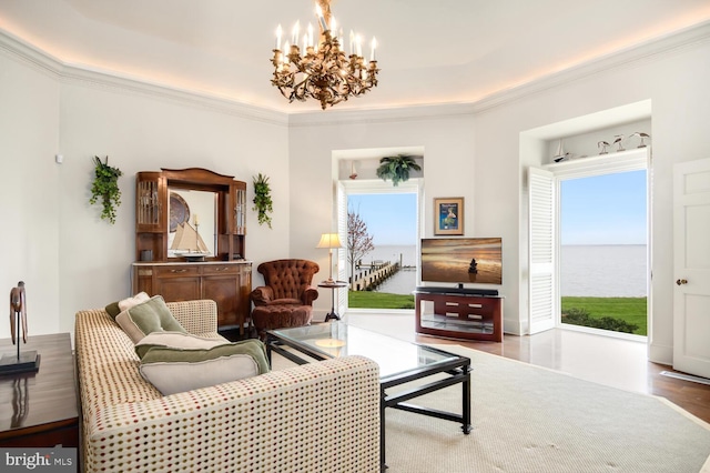 living room featuring a wealth of natural light, an inviting chandelier, and ornamental molding