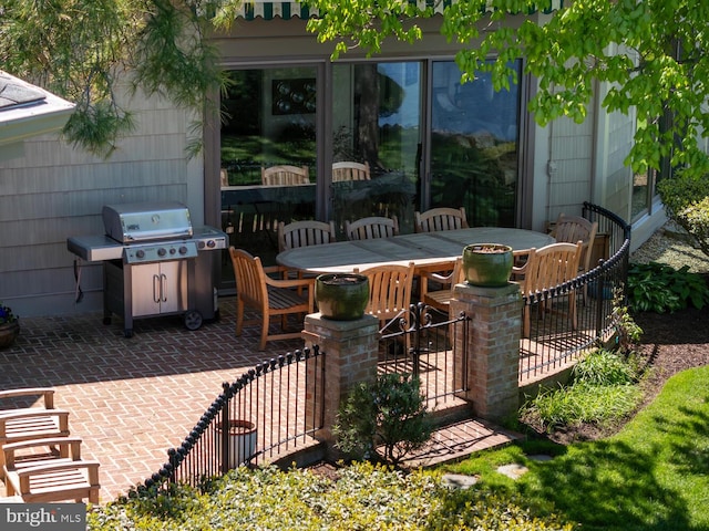 view of patio featuring outdoor dining area and a grill