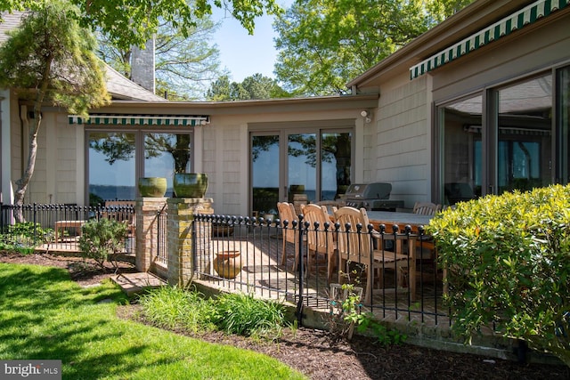 exterior space with a patio, fence, and a chimney