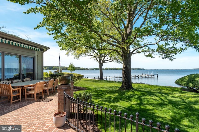 exterior space with outdoor dining space and a water view