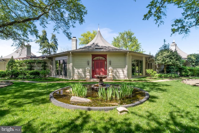 view of front of home featuring a front yard and a chimney