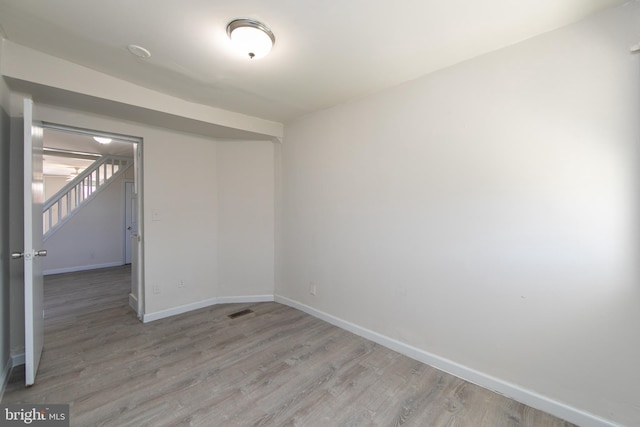 spare room featuring light wood-type flooring