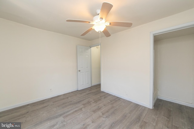 empty room featuring ceiling fan and light wood-type flooring