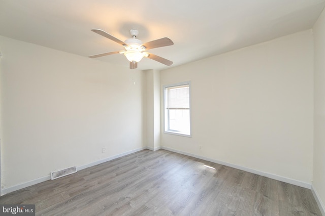 empty room featuring ceiling fan and light hardwood / wood-style floors