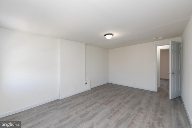 empty room with light hardwood / wood-style flooring