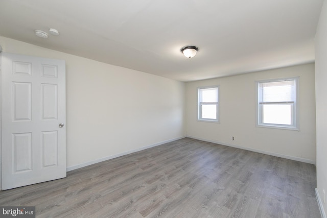 spare room with light wood-type flooring