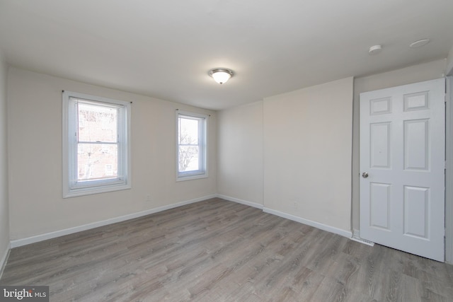 unfurnished room with light hardwood / wood-style flooring